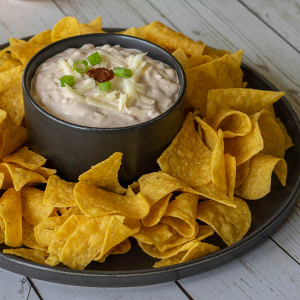 Dip in a black bowl with tortilla chips