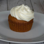 Pumpkin Cupcake with Cream Cheese Frosting on a white plate