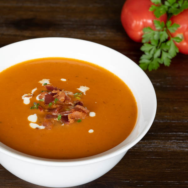 Tomato Bisque topped with bacon, thyme, and cream