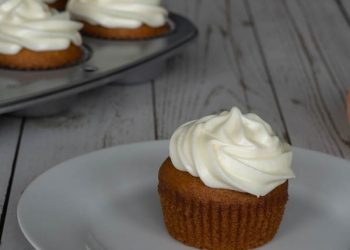 Pumpkin Cupcake with Cream Cheese Frosting on a white plate