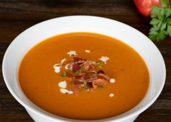 Tomato Bisque topped with bacon, thyme, and cream
